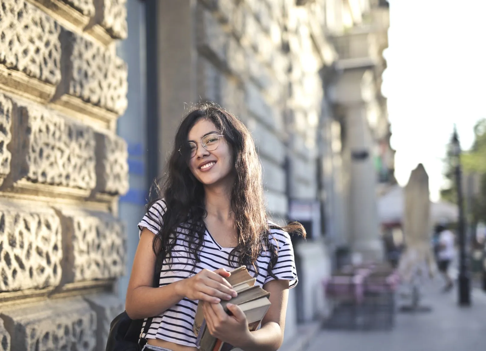 Smiling student holding her books